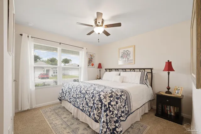 a living room with furniture a flat screen tv and a window