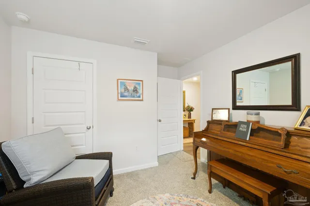 a bed room with bed and a flat tv screen on dresser