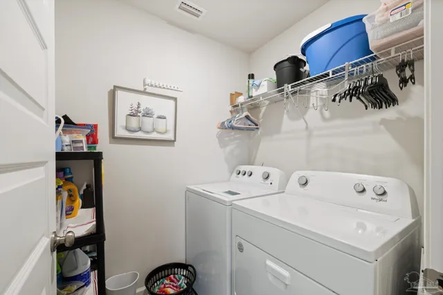 a en suite bathroom with a double vanity sink and a mirror
