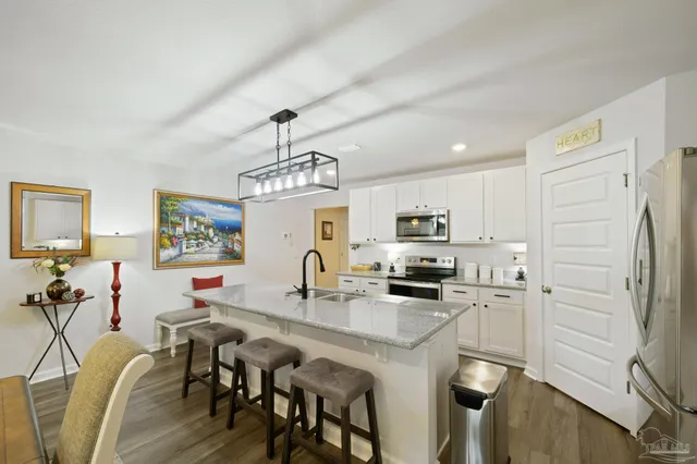 a view of a porch with a chairs and potted plants