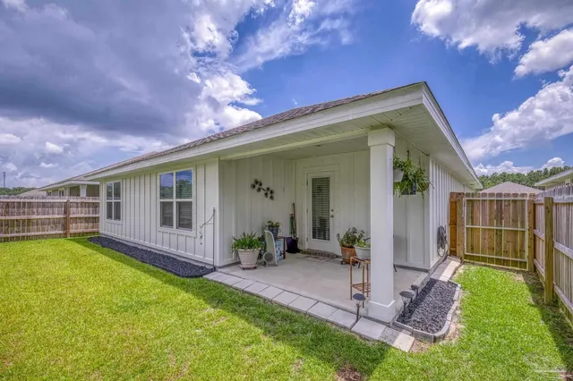 a view of a house with swimming pool and porch with furniture