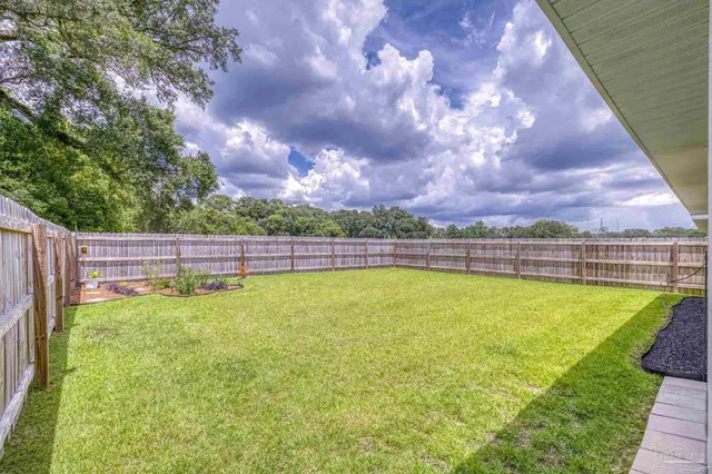 a view of house that has a yard