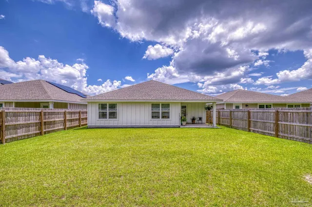 a view of yard with swimming pool and green space