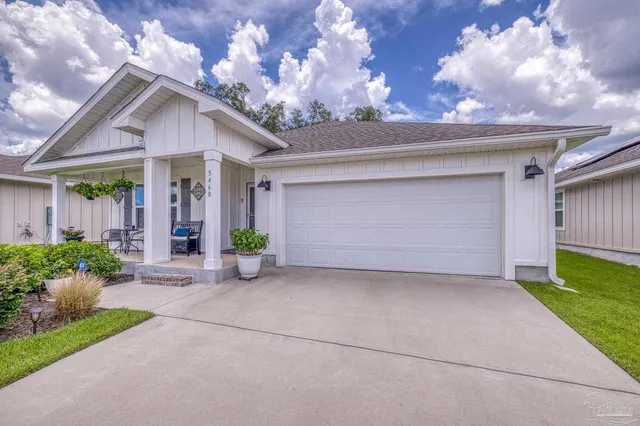 a view of a backyard with swimming pool and furniture