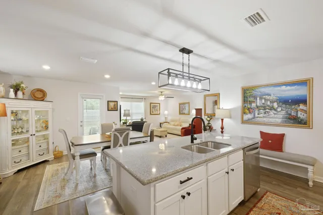 a kitchen with stainless steel appliances granite countertop a stove and a sink