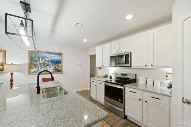 a view of a workspace with furniture and lamp