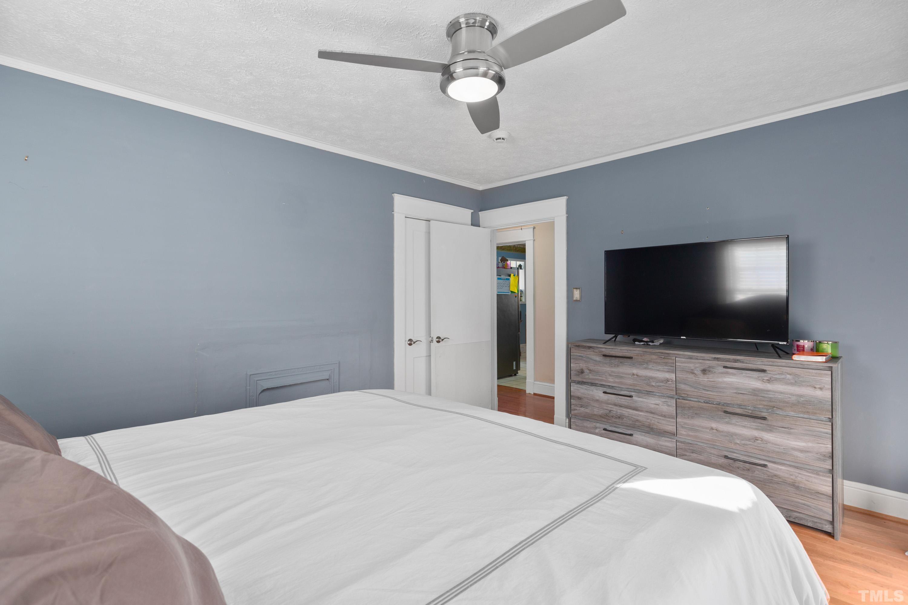 213 Edgar Street Roxboro, NC 27573 - Photo 14 of 29 a bedroom with a bed and a flat screen tv