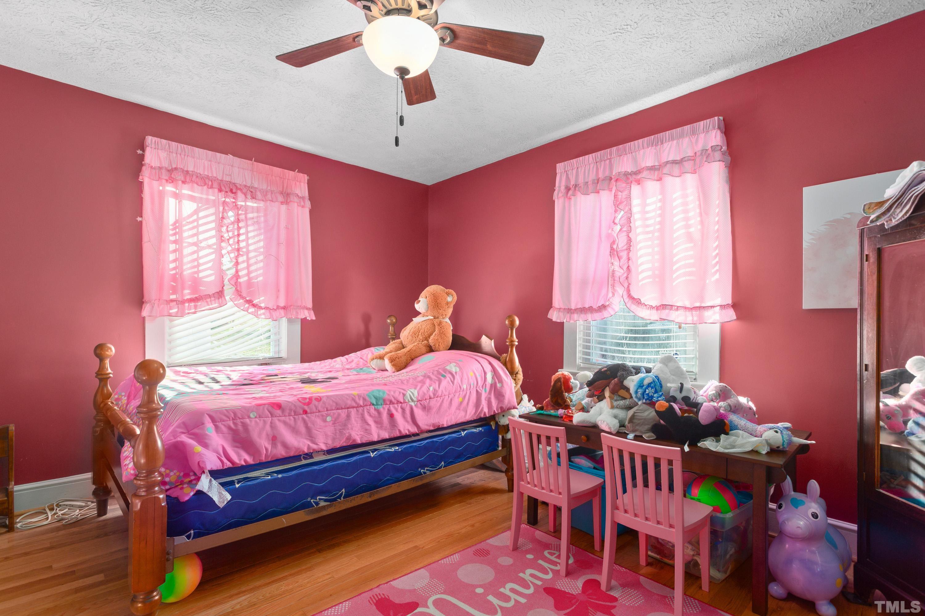 213 Edgar Street Roxboro, NC 27573 - Photo 17 of 29 a bedroom with a bed and a chandelier