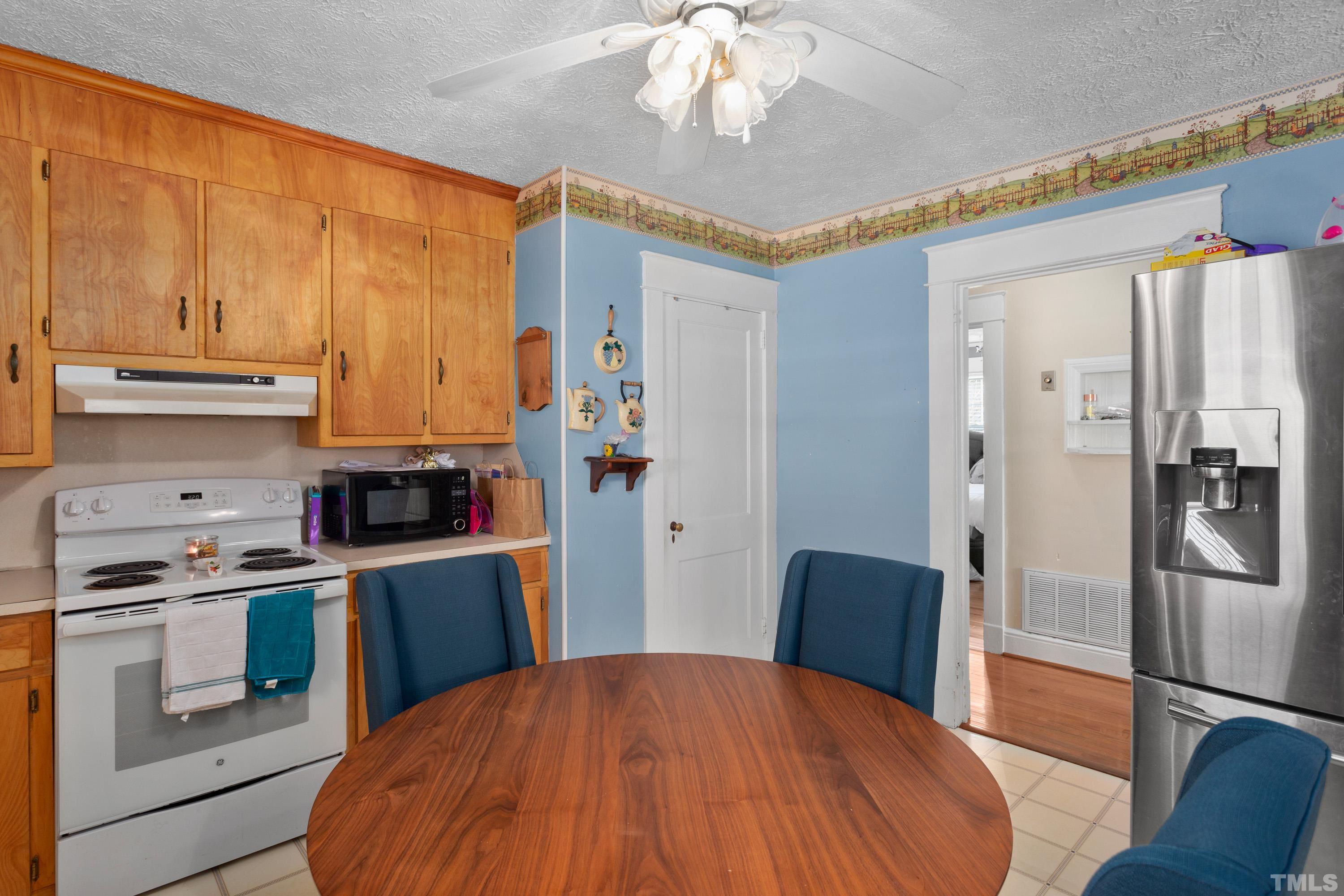 213 Edgar Street Roxboro, NC 27573 - Photo 21 of 29 a kitchen with stainless steel appliances a stove a refrigerator and cabinets