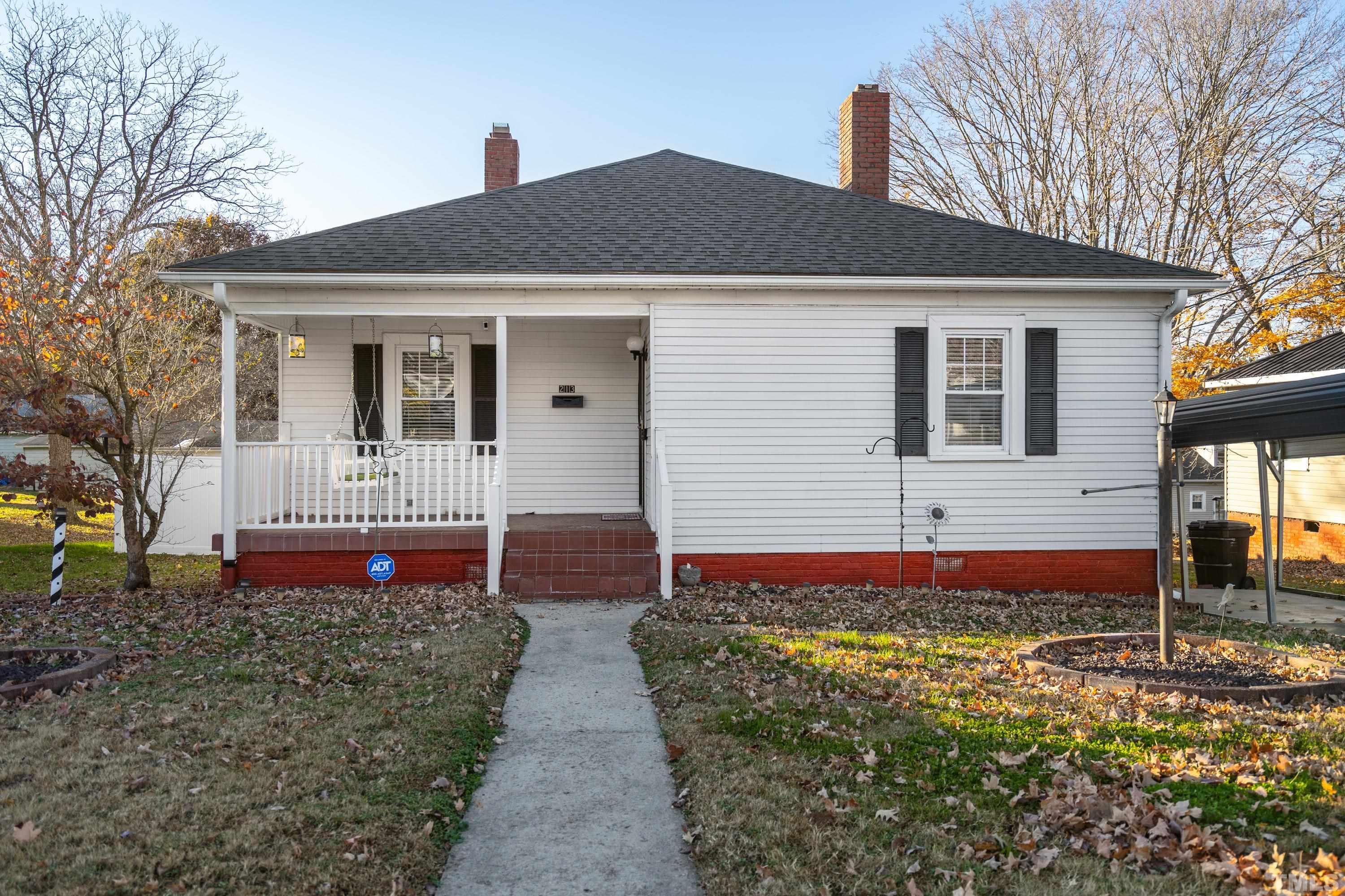 213 Edgar Street Roxboro, NC 27573 - Photo 4 of 29 a front view of a house with a yard