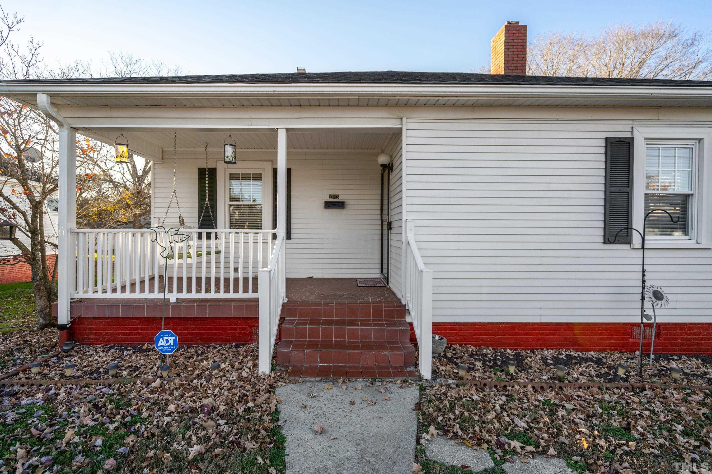 213 Edgar Street Roxboro, NC 27573 - Photo 7 of 29 a view of a house with a small yard and wooden fence