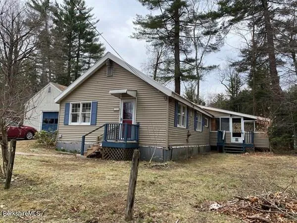 a view of a house with a yard covered in snow