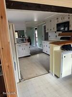 106 Shore Road Becket, MA 01223 - Photo 11 of 25 a kitchen with stainless steel appliances a refrigerator a stove a microwave a sink and cabinets