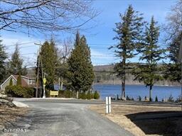 106 Shore Road Becket, MA 01223 - Photo 23 of 25 a street sign on a sidewalk next to a road