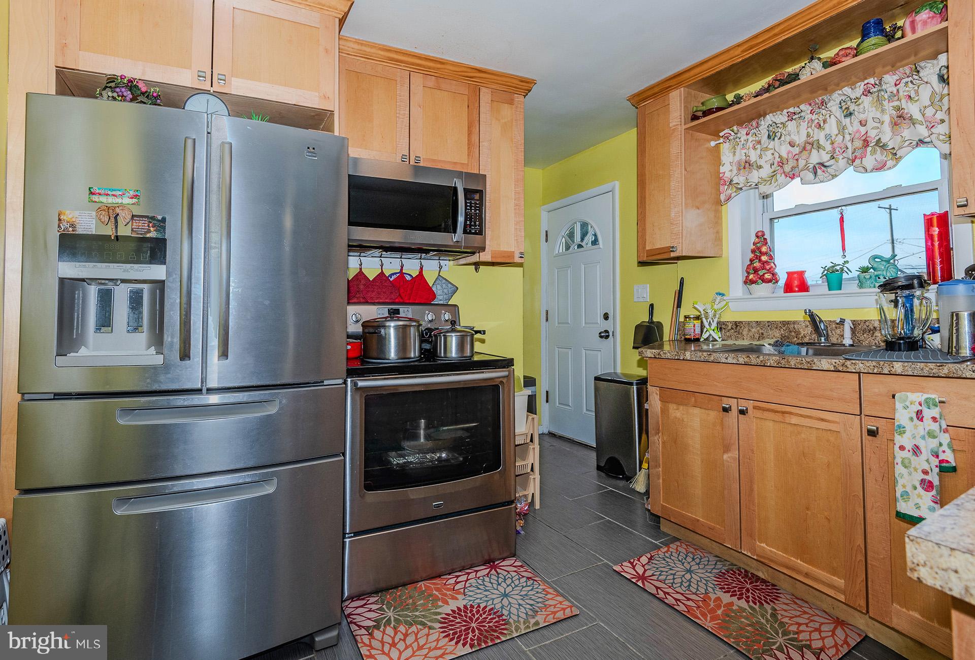 3505 South Forest Edge Road District Heights, MD 20747 - Photo 6 of 16 a kitchen with stainless steel appliances a refrigerator stove and sink