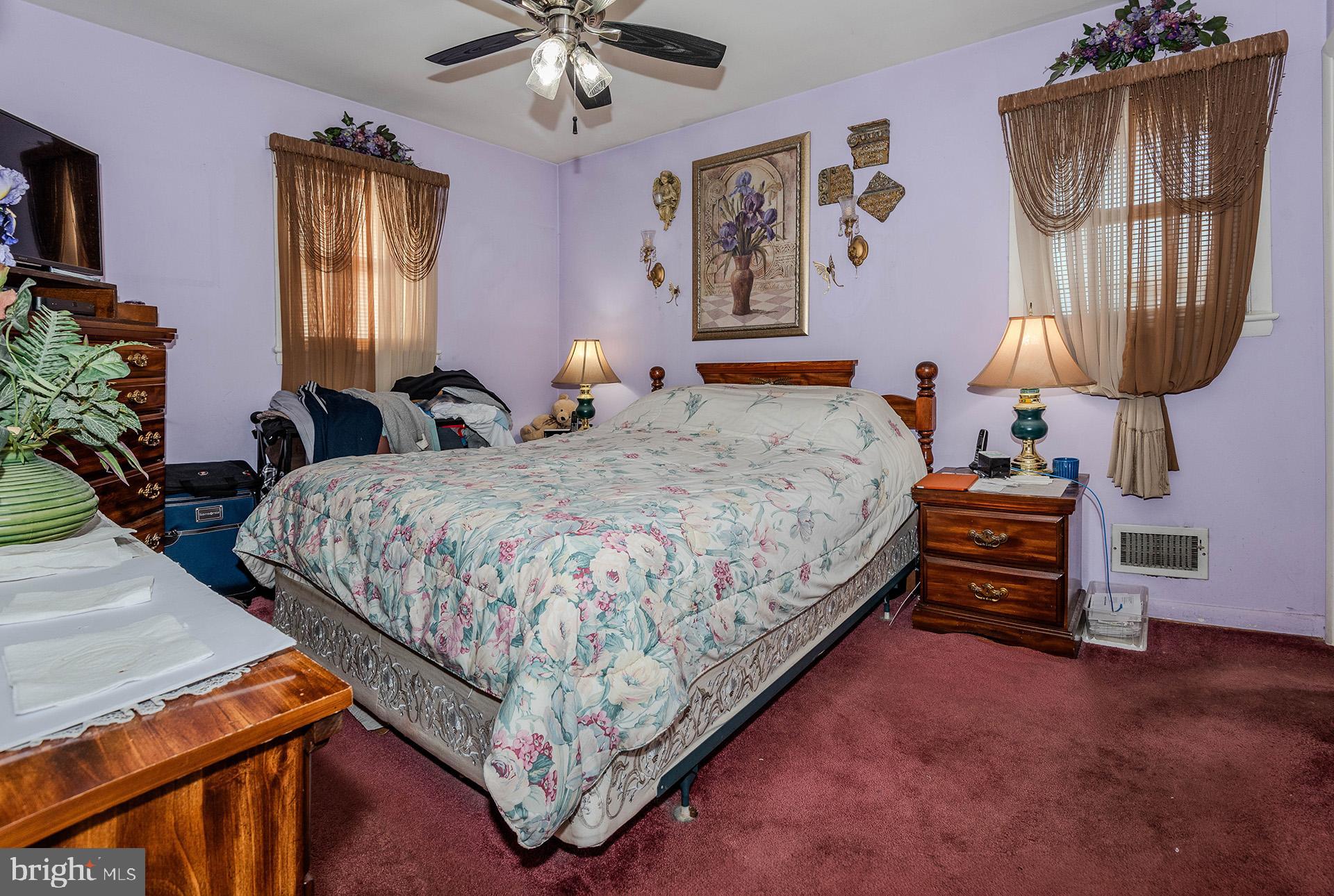 3505 South Forest Edge Road District Heights, MD 20747 - Photo 7 of 16 a bedroom with a bed a dresser and painting on the wall