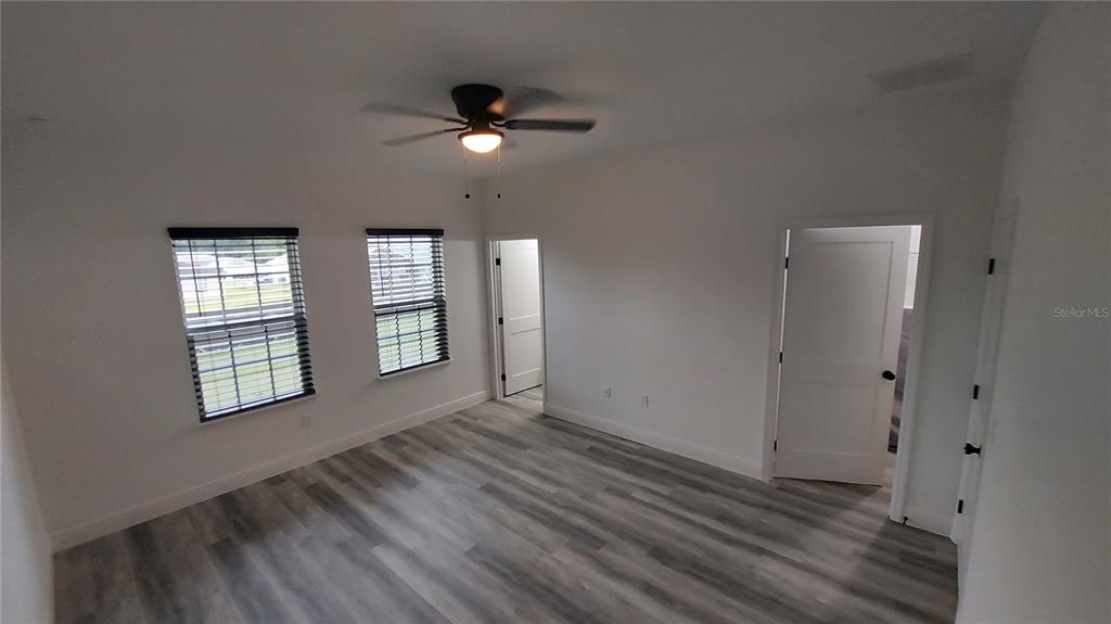 5984 Southwest 128th Street Road Ocala, FL 34473 - Photo 13 of 23 a view of an empty room with glass door and windows