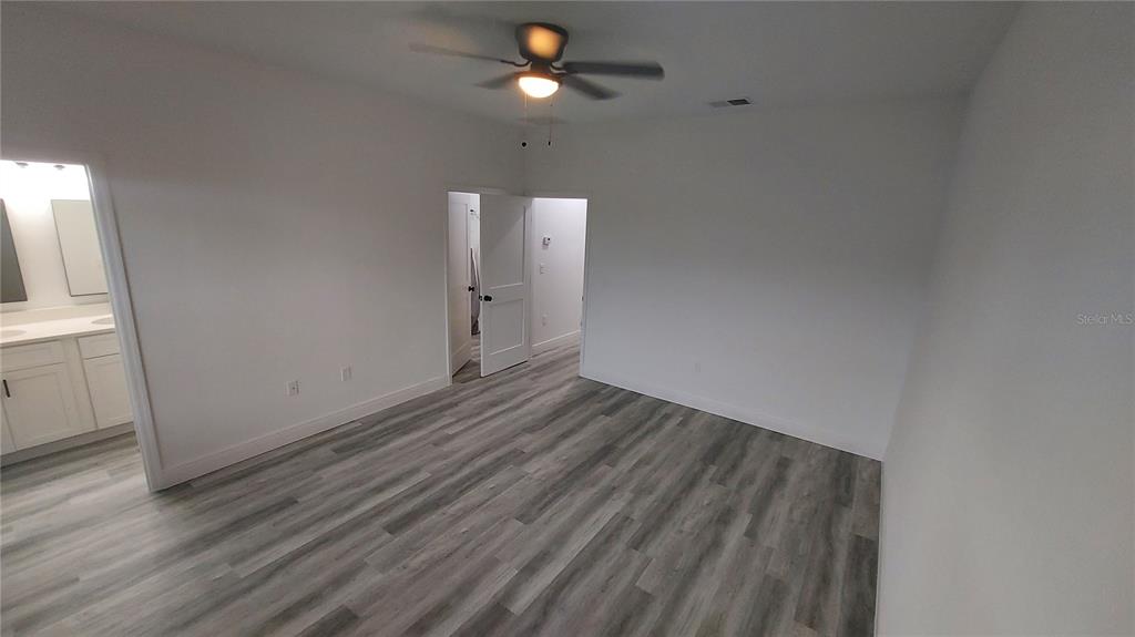 5984 Southwest 128th Street Road Ocala, FL 34473 - Photo 14 of 23 a view of empty room with wooden floor