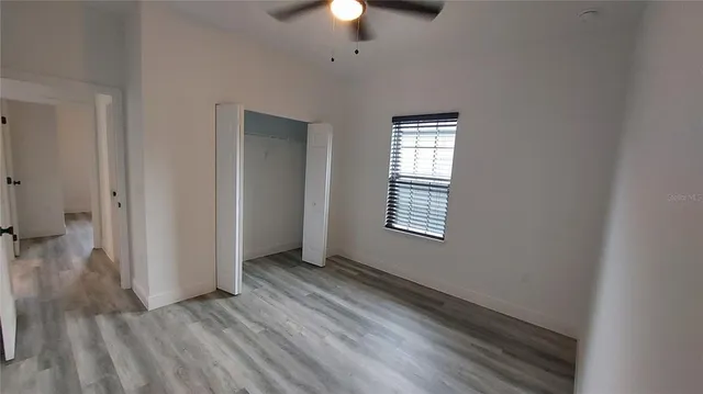 wooden floor in an empty room with a window