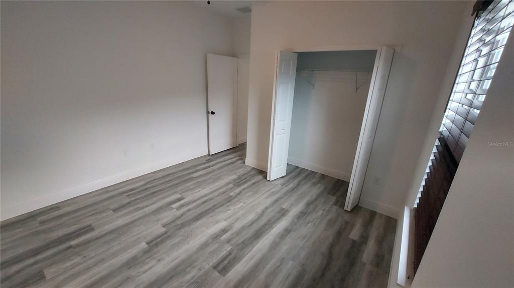5984 Southwest 128th Street Road Ocala, FL 34473 - Photo 21 of 23 a view of a room with wooden floor and staircase