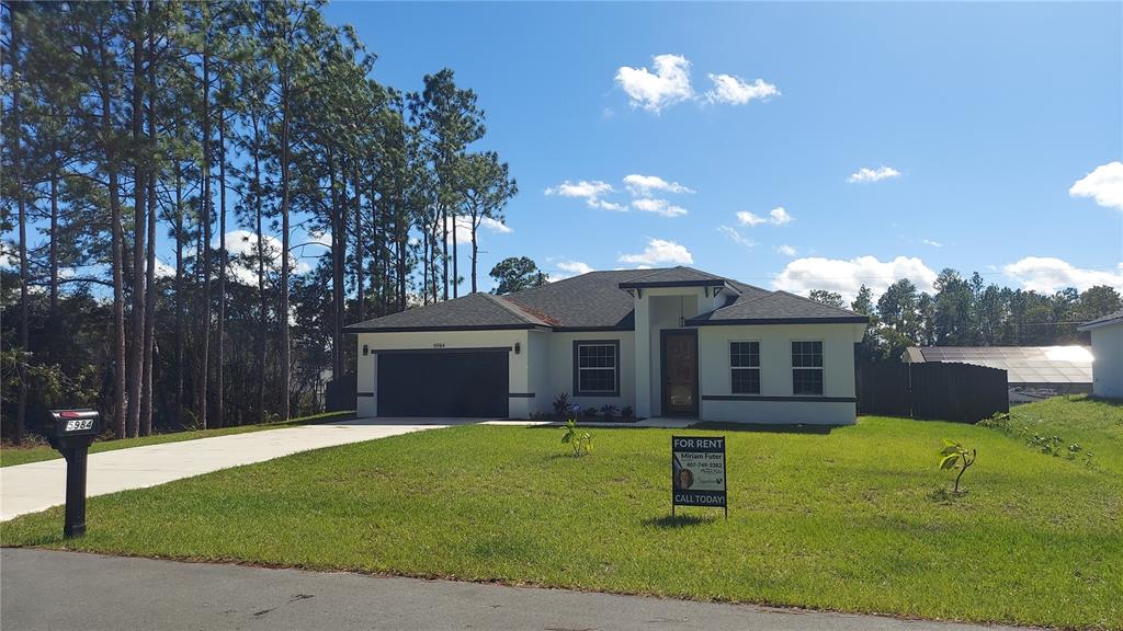 5984 Southwest 128th Street Road Ocala, FL 34473 - Photo 3 of 23 a front view of a house with a yard