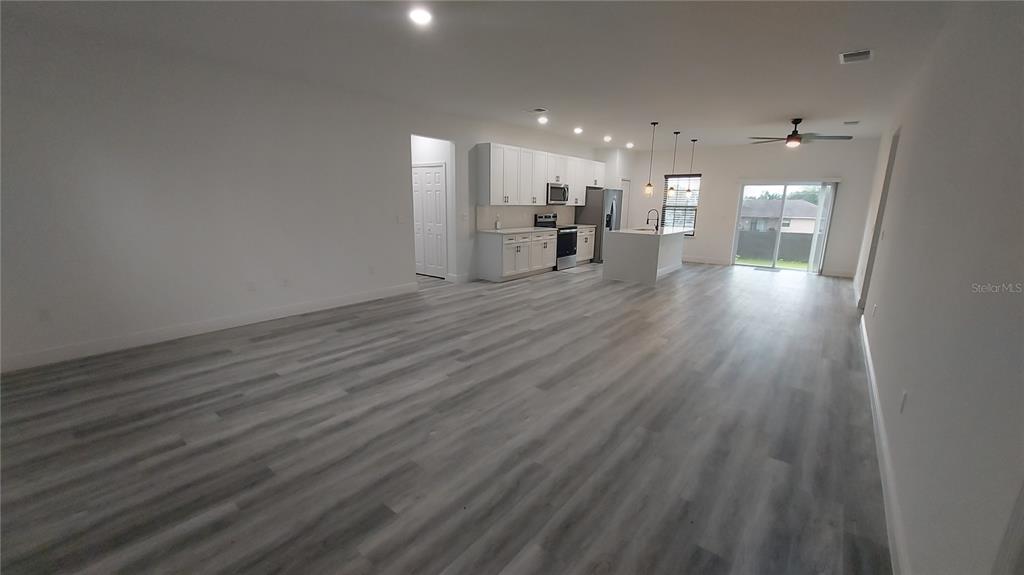 5984 Southwest 128th Street Road Ocala, FL 34473 - Photo 6 of 23 a view of kitchen and a wooden floor