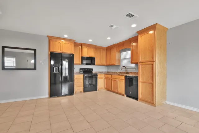 a kitchen with stainless steel appliances a refrigerator and a stove top oven