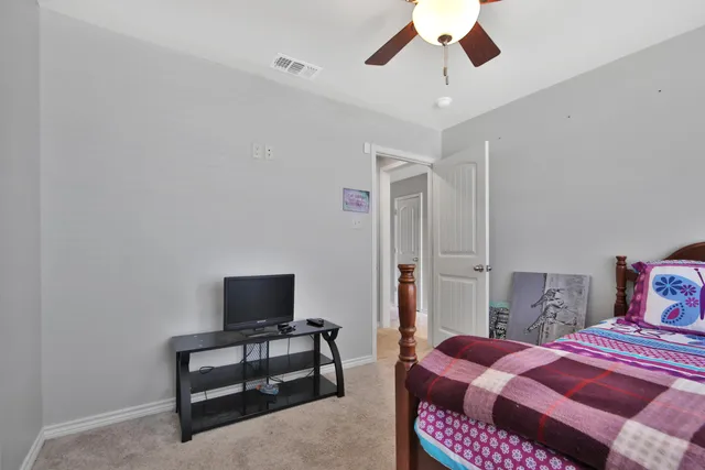 a bedroom with a bed and a chair