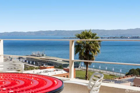 a bedroom with bed and wooden floor