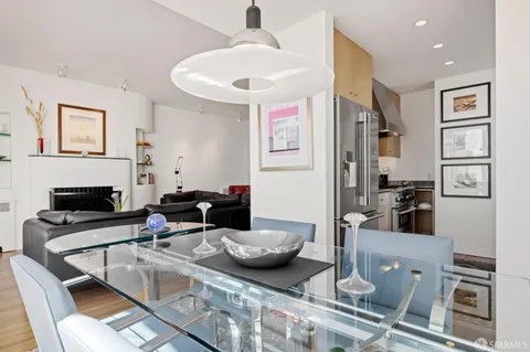 a living room with furniture a large window and a fireplace