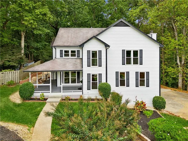 a front view of a house with garden