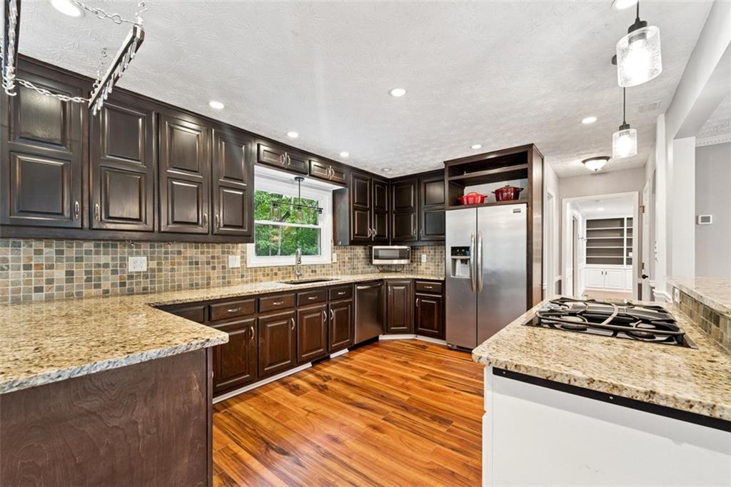 2017 Parsons Ridge Duluth, GA 30097 - Photo 12 of 53 a kitchen with stainless steel appliances granite countertop a sink stove and refrigerator