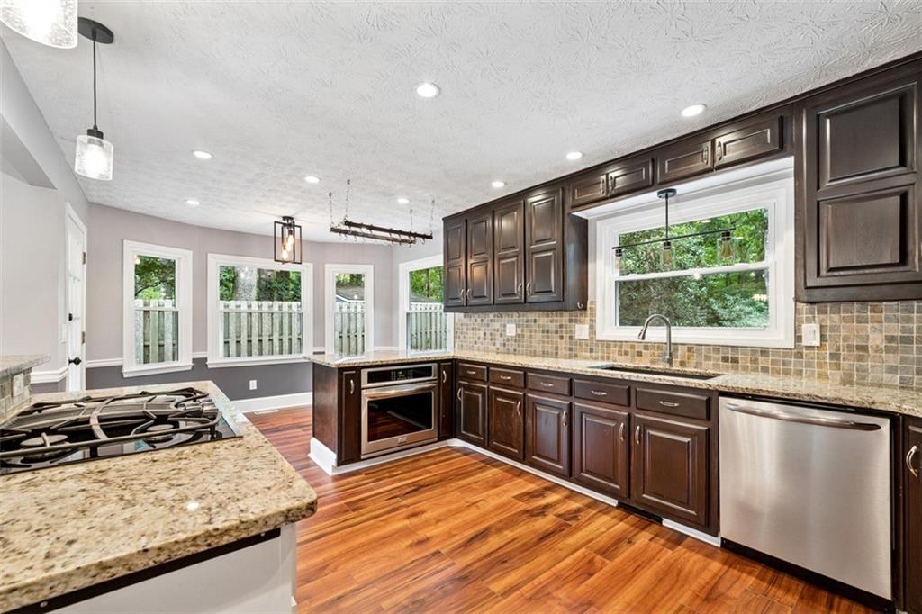 2017 Parsons Ridge Duluth, GA 30097 - Photo 13 of 53 a kitchen with stainless steel appliances granite countertop sink stove and refrigerator