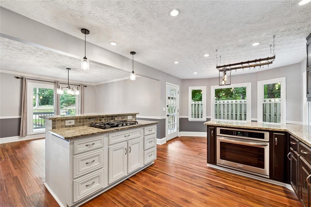 2017 Parsons Ridge Duluth, GA 30097 - Photo 14 of 53 a kitchen with stainless steel appliances granite countertop a stove and a wooden floors