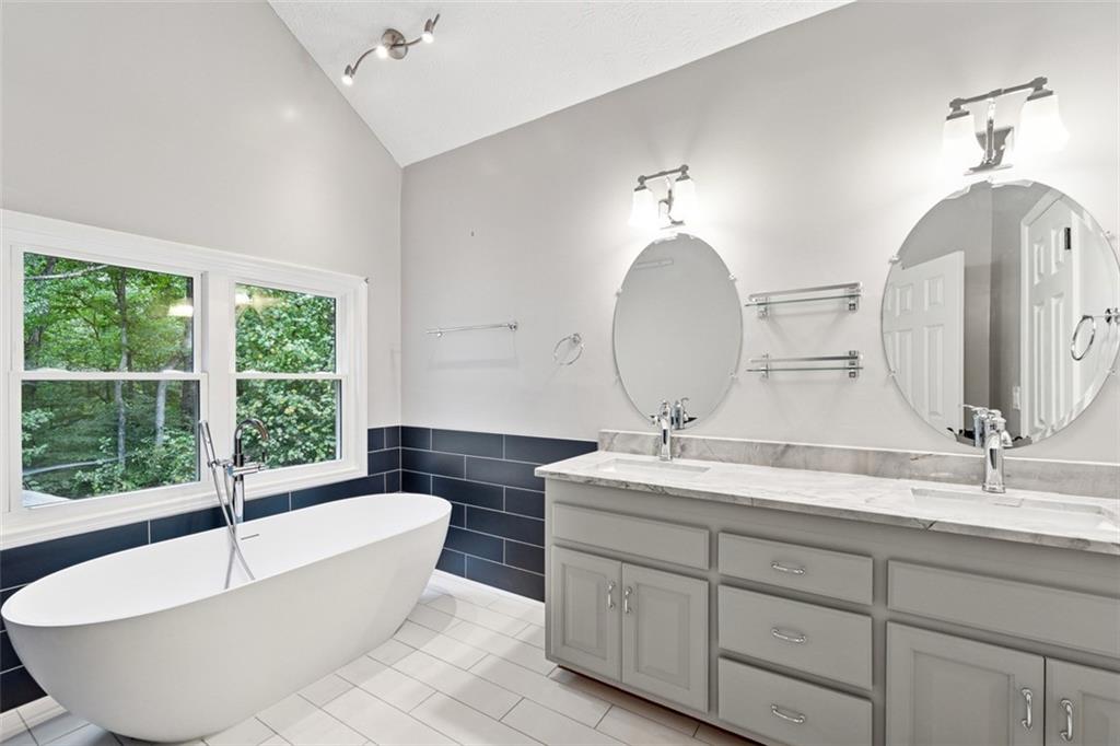2017 Parsons Ridge Duluth, GA 30097 - Photo 24 of 53 a spacious bathroom with a double vanity sink large mirror and a bathtub