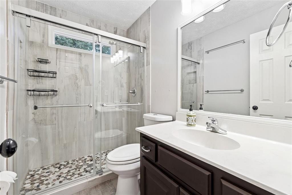 2017 Parsons Ridge Duluth, GA 30097 - Photo 34 of 53 a bathroom with a sink a toilet a shower and a mirror