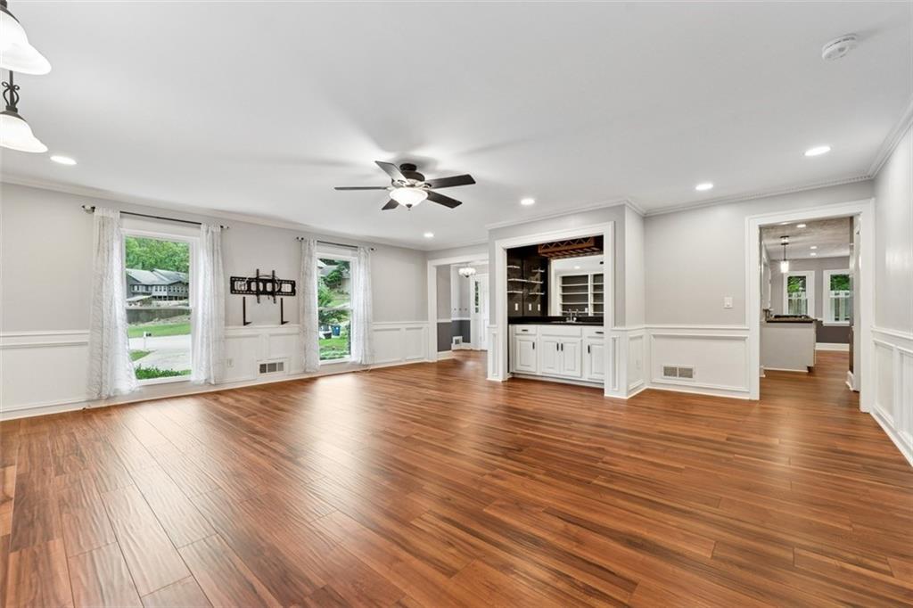 2017 Parsons Ridge Duluth, GA 30097 - Photo 8 of 53 a view of an empty room with wooden floor and a kitchen