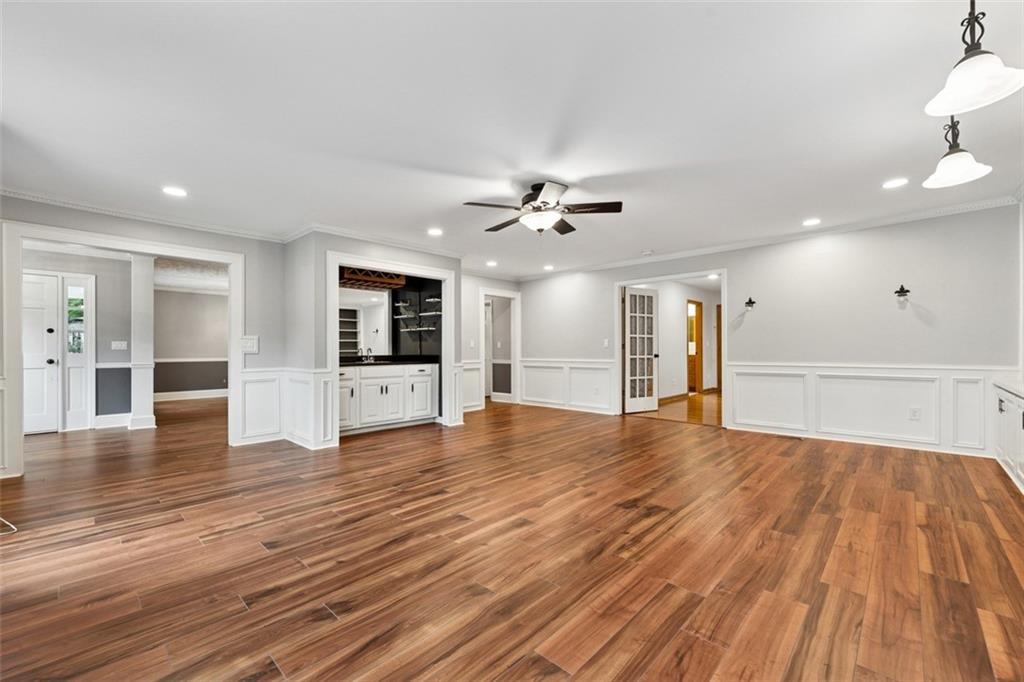 2017 Parsons Ridge Duluth, GA 30097 - Photo 9 of 53 a view of an empty room with wooden floor and a kitchen