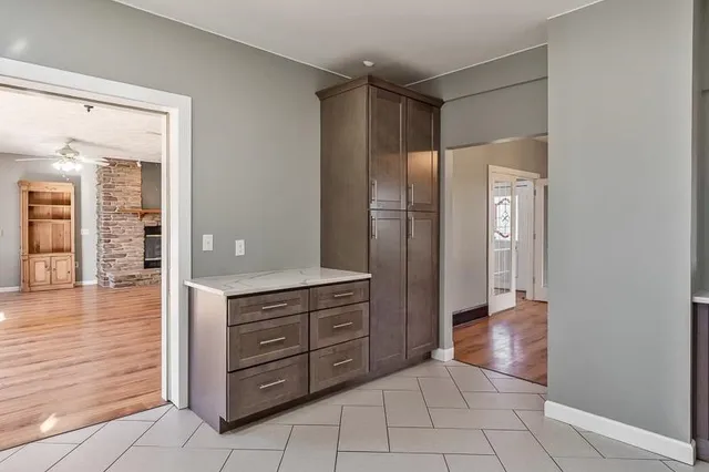 a view of empty room with wooden floor and floor to ceiling window