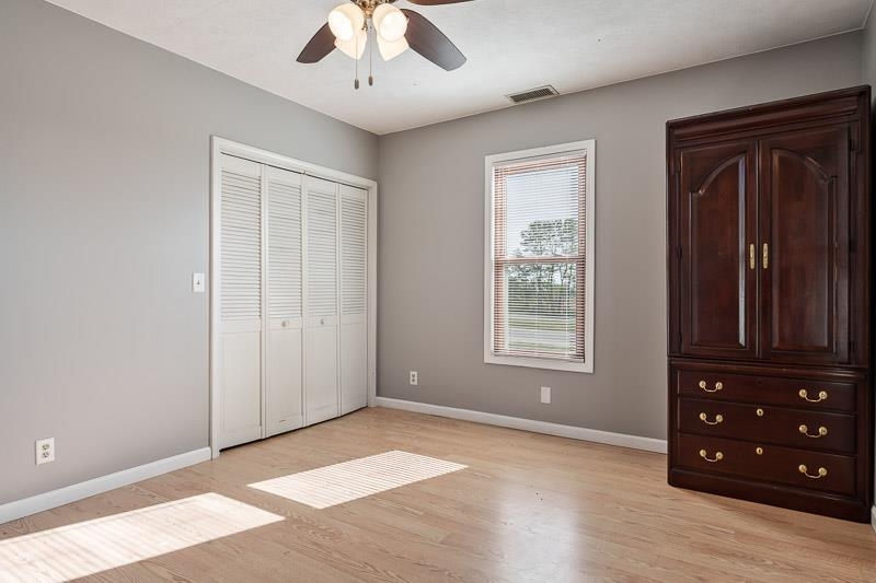 15685 West State Road Pecatonica, IL 61063 - Photo 26 of 69 a view of an empty room with a window and wooden floor