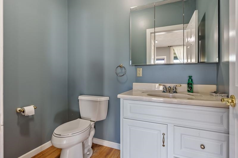 15685 West State Road Pecatonica, IL 61063 - Photo 47 of 69 a bathroom with a granite countertop toilet a sink and mirror