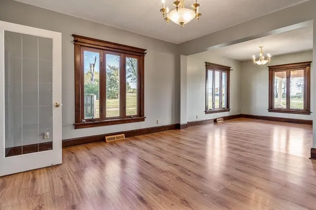 a large kitchen with granite countertop a stove a sink dishwasher a refrigerator and wooden cabinets