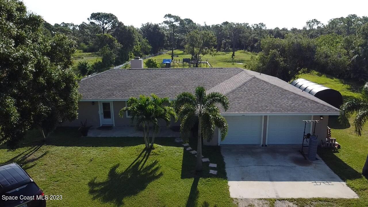2745 Corey Road Malabar, FL 32950 - Photo 19 of 39 a view of an house with backyard space and garden