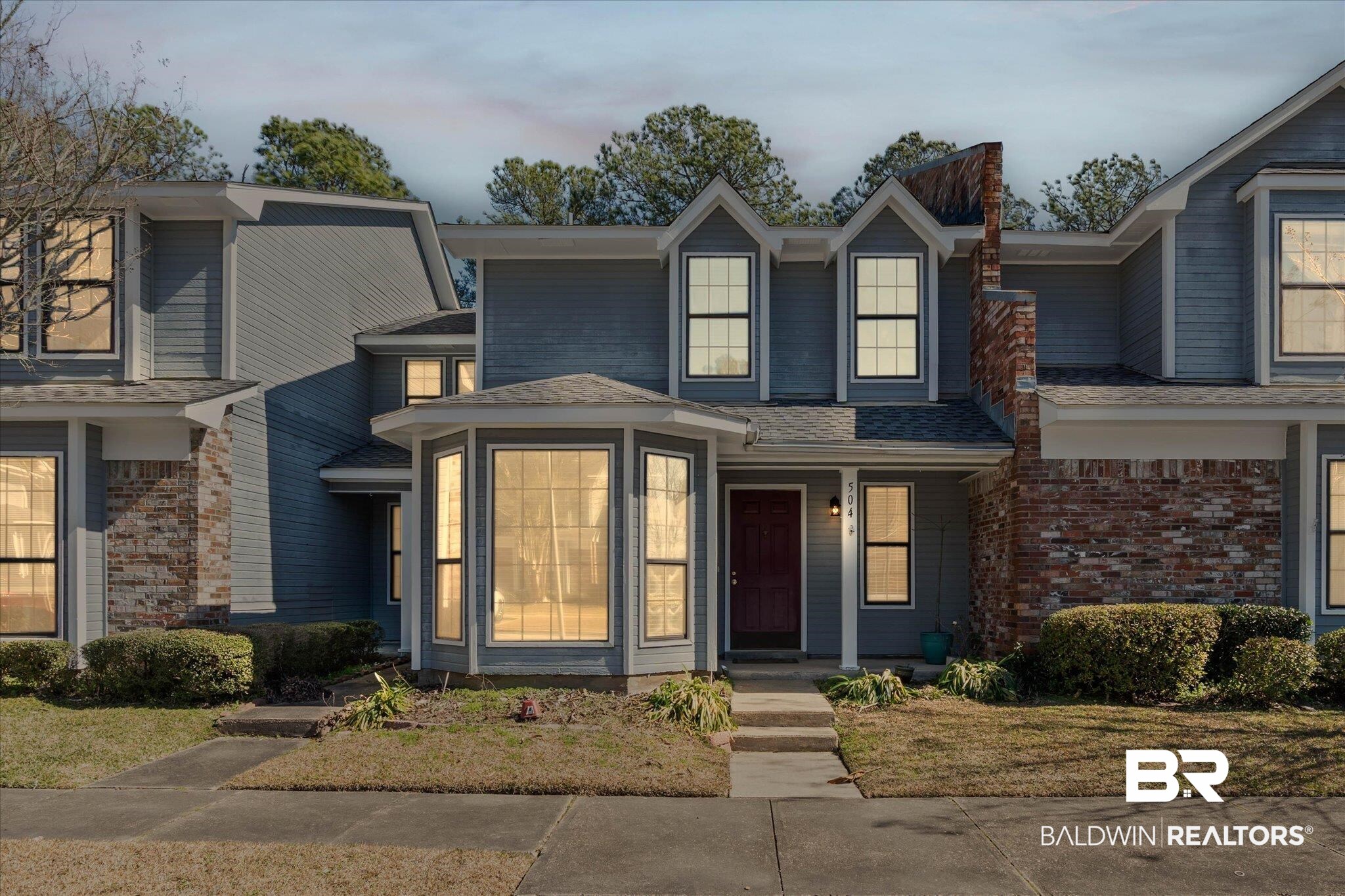 5900 Grelot Road, Unit 504 Mobile, AL 36609 - Photo 1 of 24 Traditional home with a porch and roof with shingles