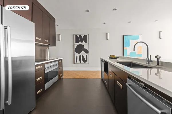 a kitchen with stainless steel appliances a sink stove and refrigerator