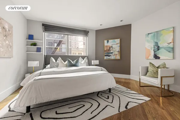 a bed room with a bed mirror and a lamp