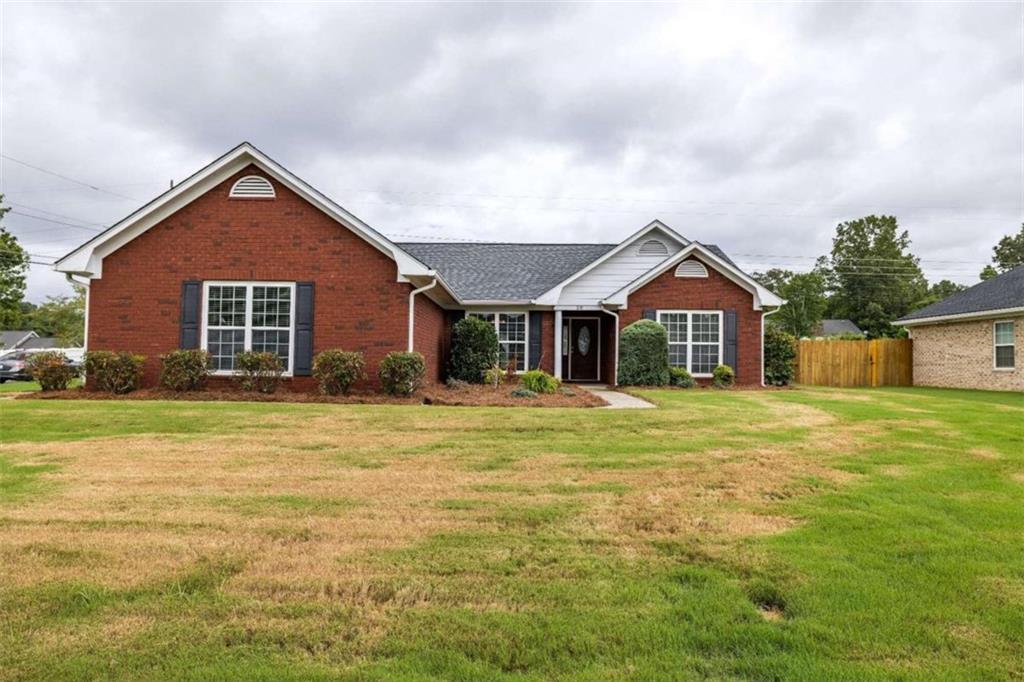 a front view of a house with a garden