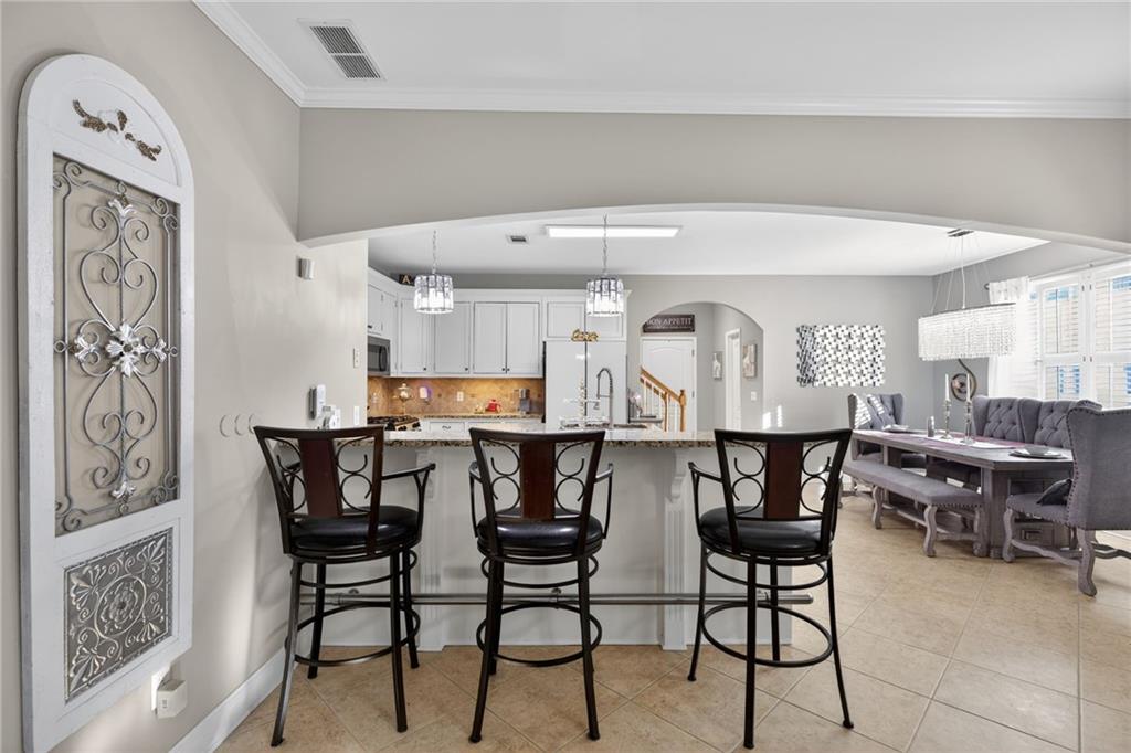 4817 Pepper Tree Lane Douglasville, GA 30135 - Photo 17 of 65 a view of a dining room with furniture and wooden floor