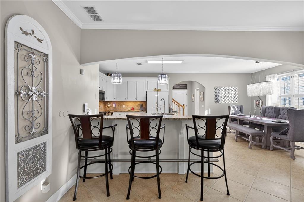 4817 Pepper Tree Lane Douglasville, GA 30135 - Photo 18 of 65 a view of a dining room with furniture and wooden floor