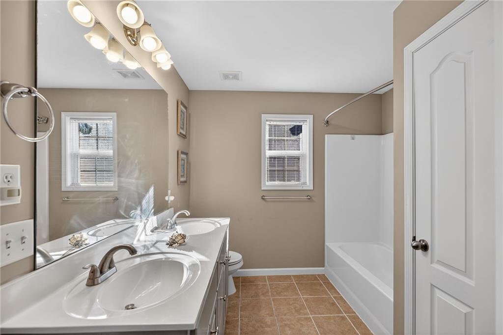 4817 Pepper Tree Lane Douglasville, GA 30135 - Photo 38 of 65 a bathroom with a sink and a mirror